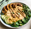 Tortilla Española surrounded by salad, delicata squash and avocado