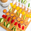 bamboo pick board seen from above, featuring veggies skewered on toothpicks